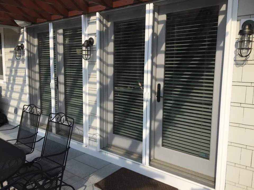 Retractable screen door drawn across an open doorway