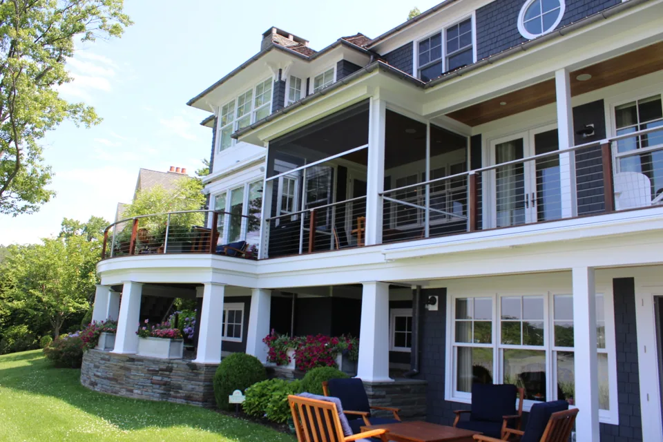 Retractable power screen shading a residential patio