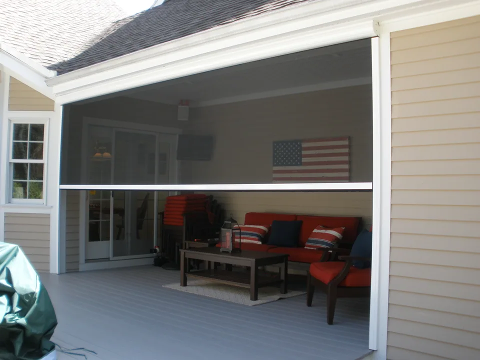 Retractable power screen fully lowered across an opening