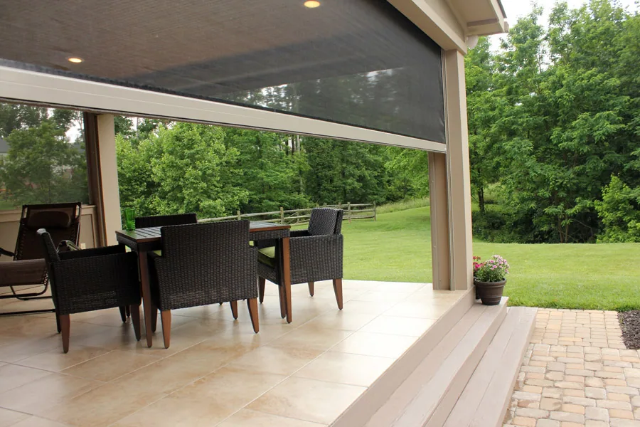 Covered patio in the evening with a retractable power screen in place
