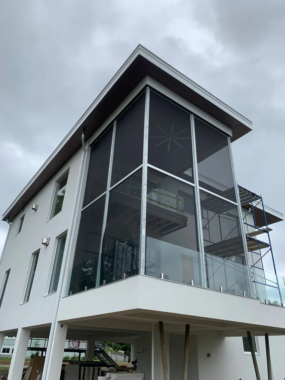 Full-height Screen Wall System panels enclosing a covered porch