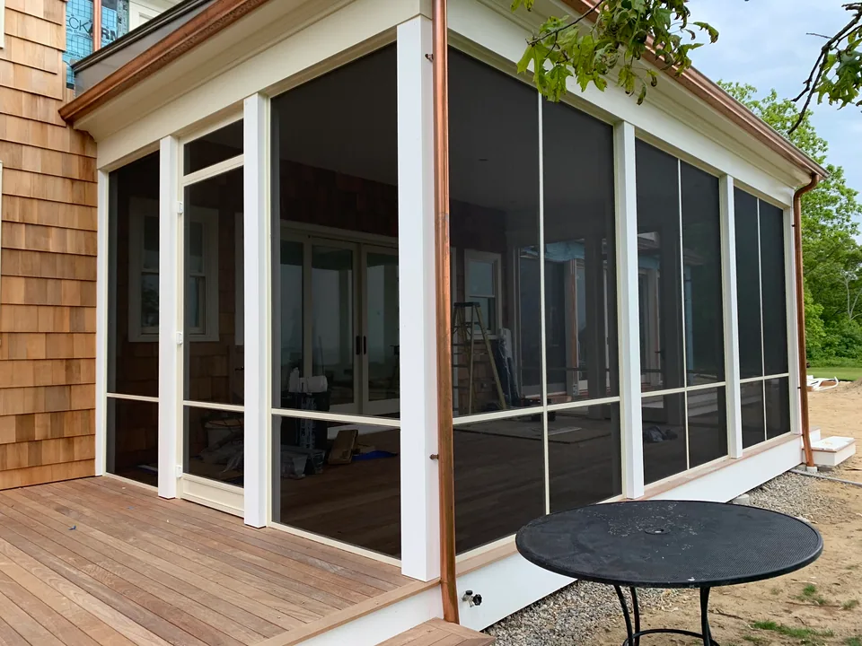 Run of Screen Wall System panels with divider bars across a patio