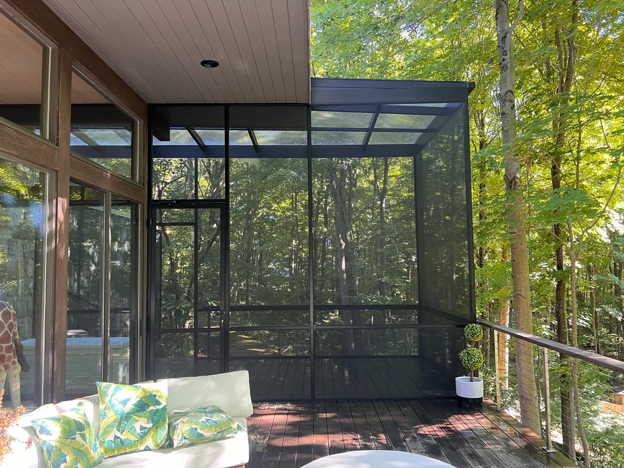 Run of screen wall panels along the side of a covered porch